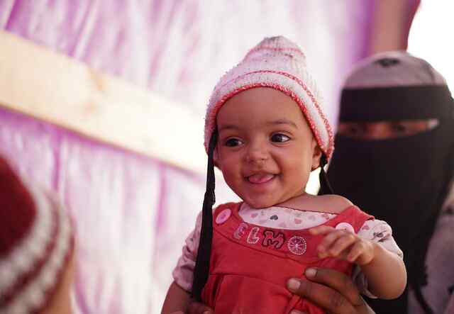 A Yemeni mother holds her small child